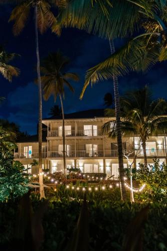 a hotel with christmas lights in front of palm trees at St. Regis Bahia Beach Resort, Puerto Rico in Rio Grande