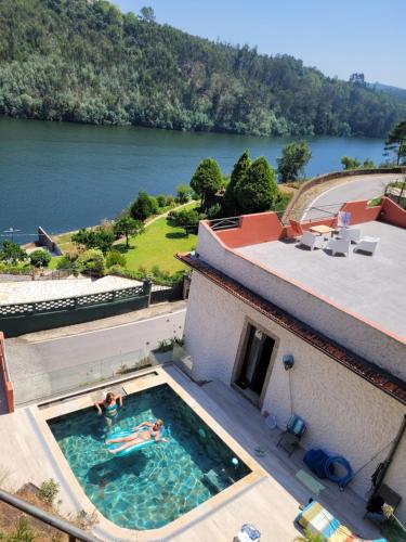 a swimming pool with a view of a river at Casa branca in Porto Carvoeiro
