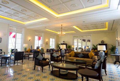 a lobby with couches and tables and chairs at Rumah Luwih Bali in Keramas