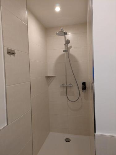 a bathroom with a shower with a glass door at Seehotel Ecktannen in Waren