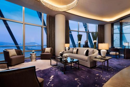 a living room with furniture and large windows at JW Marriott Hotel Shenzhen Bao'an International Airport in Bao'an