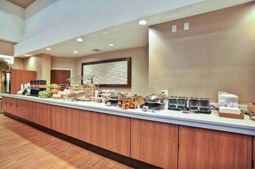 a large kitchen with a long counter in a hotel at Springhill Suites by Marriott Chicago Elmhurst Oakbrook Area in Elmhurst