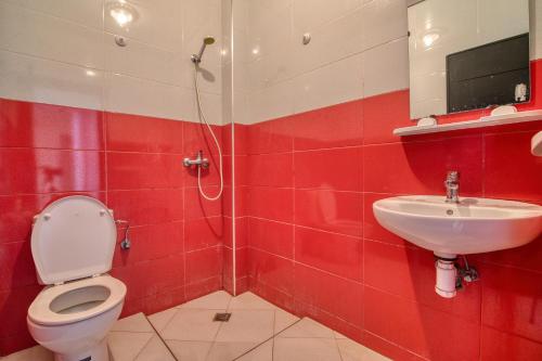 a bathroom with a toilet and a sink at Pearl Surf Camp Morocco in Agadir
