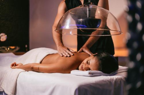 a woman getting a massage at a spa at Hard Rock Hotel Tenerife in Adeje