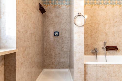 a bathroom with a shower with a tub and a sink at Dimora Svaizer, Terzolas Ospitar in Terzolas