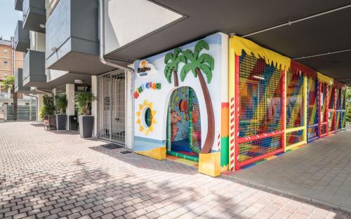 a building with a colorful mural on the side of it at Costa Rica Bibione SPA in Bibione