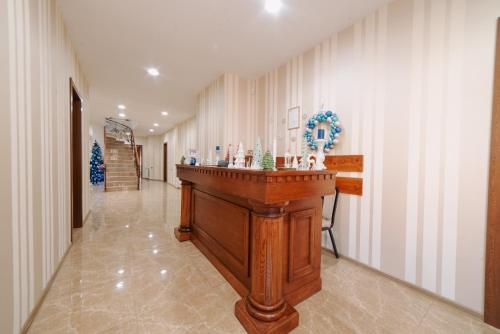 a hallway with a wooden bar in a building at Natali Hotel in Borjomi