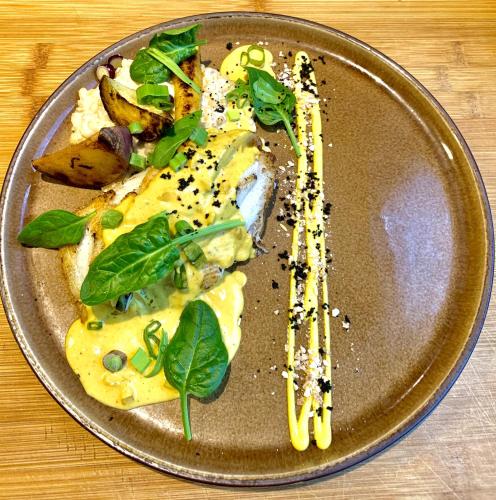 a plate of food on a wooden table at Le Sens Six in Montpellier