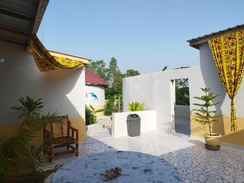 a courtyard of a house with a patio at Senegambia Birding Lodge - Full board - Bird Photohide in Mandinari