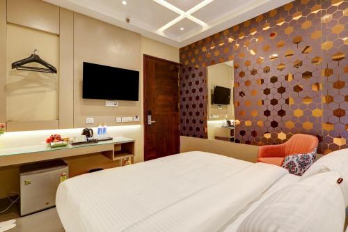 a bedroom with a bed and a desk and a tv at The Viking Hotel- 5 Minutes away from New Delhi Railway & Connaught Place in New Delhi