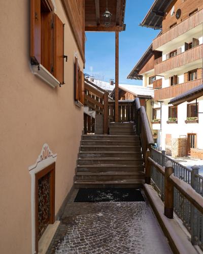 a stairway leading up to a building with wooden stairs at Sweet Suite in Sappada