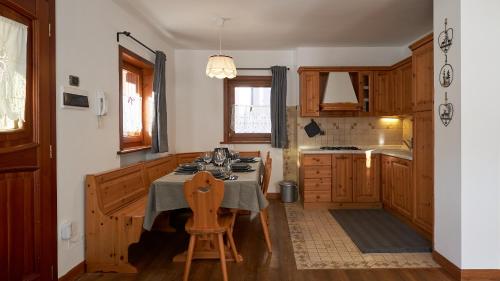 a kitchen with a table and a chair in it at Sweet Suite in Sappada