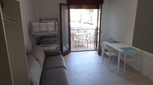 a living room with a couch and a table at Residence Bristol Bibione in Bibione