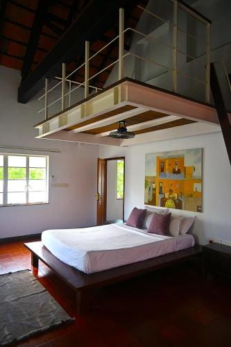a bedroom with a large white bed in a room at Kara Fort Kochi in Fort Kochi