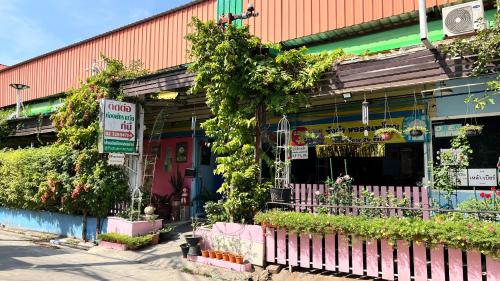 a flower shop with a fence in front of it at Pa Chalermchai Guesthouse in Bangkok