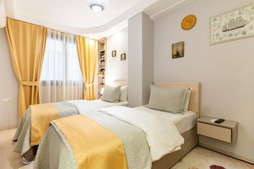 a bedroom with two beds and a window at A cozy smart home in Kusadasi Old Town in Kusadası