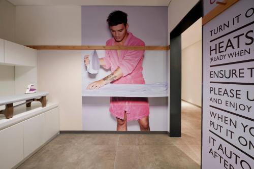 a man standing in a bunk bed in a room at Moxy Seoul Insadong in Seoul