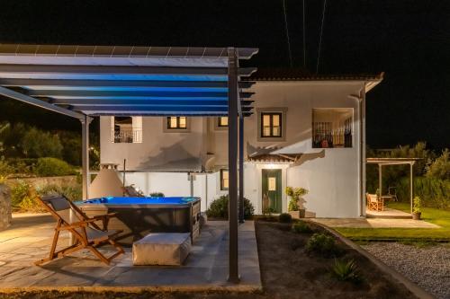 a pool table on a patio at night at Marani Home & Villas in Skopelos Town