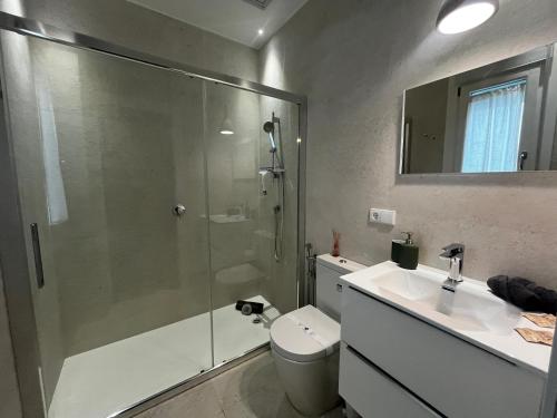 a bathroom with a shower and a toilet and a sink at Kadis-Korazon Grupo AC Gestion in Cádiz