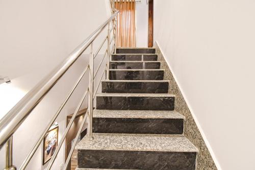 a flight of stairs in a building with white walls at FabExpress Golden Suites - Nr Park Circus 7 point in Kolkata