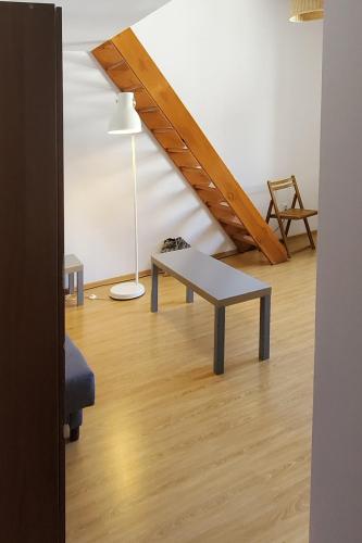 a living room with a bench and a table at Take a rest in the center of Krakow, Zyblikiewicza in Kraków