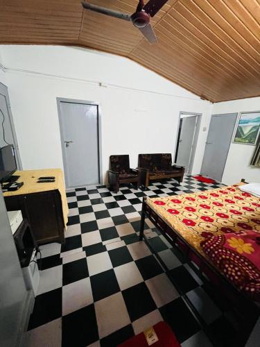 a room with a bed and a checkered floor at GreenSpot Homestay in Idukki