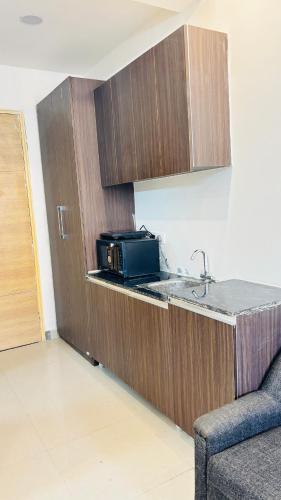 a kitchen with a sink and a microwave on a counter at shri ram properties in Ghaziabad
