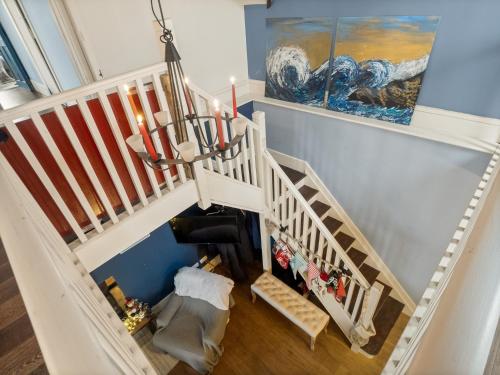 a staircase in a home with a white stair case at Suantrai Cottage in Roundstone