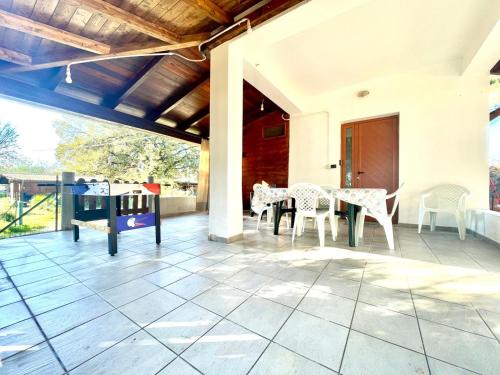 a patio with a table and chairs on it at Sea Breeze Home in Lotzorai