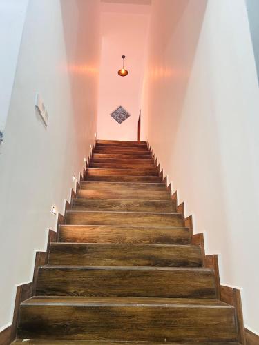 a staircase in a building with a pink wall at Sun Rusiru villa in Koggala