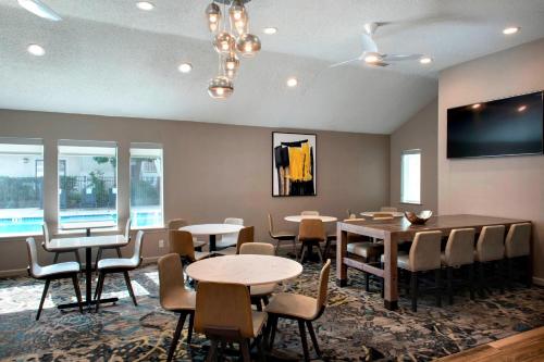 a dining room with tables and chairs and windows at Residence Inn Philadelphia Valley Forge in Berwyn