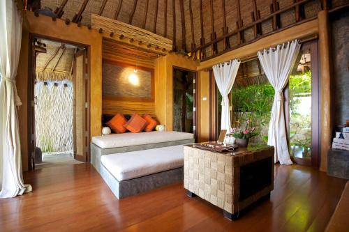 a bedroom with a bed and a table in a room at View Point Resort in Koh Tao