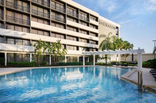 a large swimming pool in front of a building at Sheraton Orlando North in Orlando