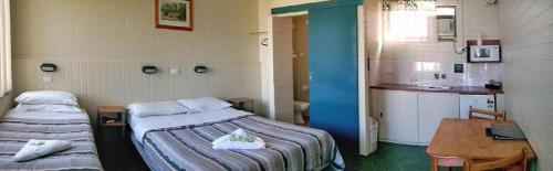 Ein Bett oder Betten in einem Zimmer der Unterkunft Dubbo Midstate Motor Park