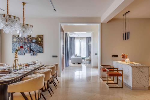 a dining room with a long bar and chairs at Vilasa 5 BHK by tisyastays in Vagator