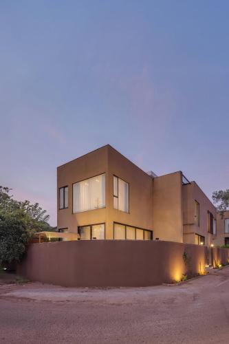 a building with a fence in front of it at Vilasa 5 BHK by tisyastays in Vagator