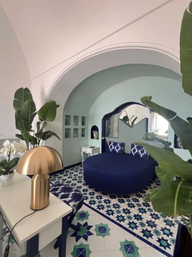 a bedroom with a blue bed and a table at Hotel Marincanto in Positano