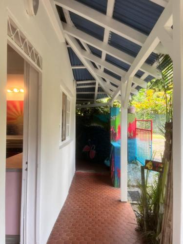 a hallway of a house with a blue ceiling at Wonderland Rooms in Petit-Bourg