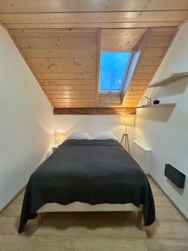 a bed in a small room with a window at Beskid Bukowa in Szczyrk