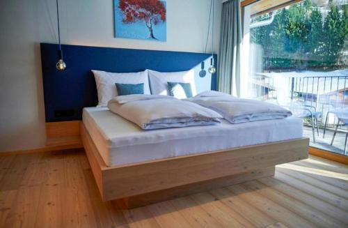 Postel nebo postele na pokoji v ubytování Wellness und Brunch Hotel MorgenZeit beheizter Naturpool mit Sandstrand Genuss Frühstück bis 13 Uhr Hochkönig Sommercard