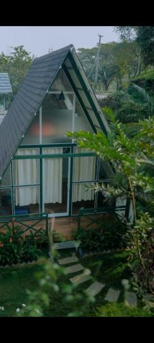 a small house with a gambrel roof at Royal Woods in Meppādi