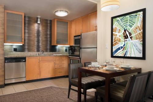 a kitchen with a wooden table and a dining room at Residence Inn by Marriott Camarillo in Camarillo