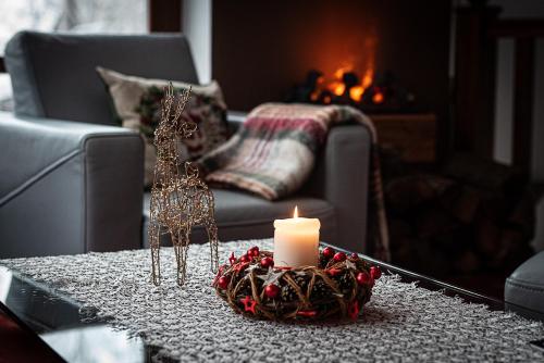a living room with a candle on a coffee table at Hotel Promyk Wellness & Spa in Karpacz
