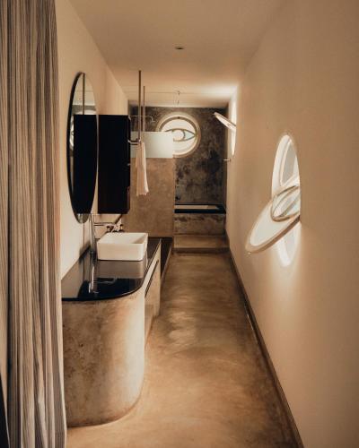a bathroom with a sink and a mirror at Kara Fort Kochi in Fort Kochi