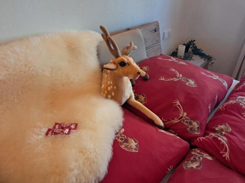 a stuffed deer sitting on top of a bed at das historische MEIXNER am Rerobichl Bezirk Kitzbühel in Oberndorf in Tirol