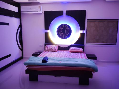 a bedroom with a bed in a purple room at Kutir Stay in Secunderabad