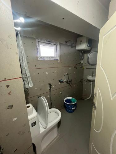 a small bathroom with a toilet and a window at siddhwe homestay and restaurant in Sonāda
