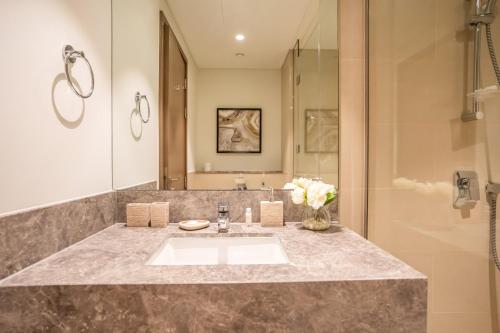 a bathroom with a sink and a shower at NewArabian Act Two T2 2 BR and 3 BR in Dubai