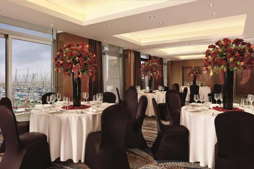 a conference room with tables and chairs with flowers at The Ritz-Carlton, Herzliya in Herzelia 