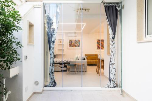 a glass door leading into a living room at Da Nonno Ciccio 2 in Valenzano